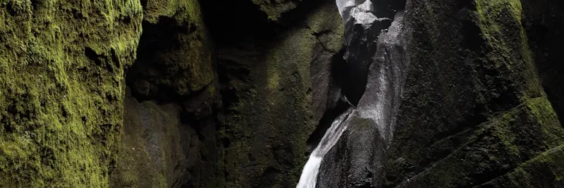 Groupe en rappel dans un canyon près d'une cascade